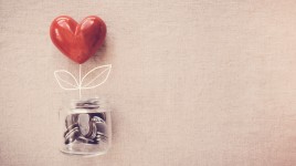 Heart shaped balloon holding a jar of donations